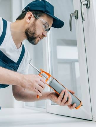 Man Fixing a Glass Window